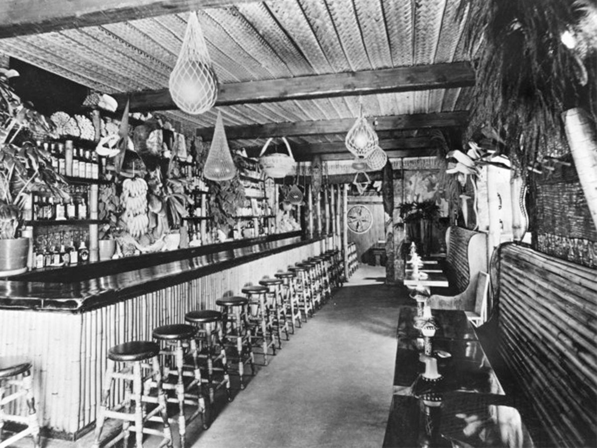 Interior of a tiki bar showing the full bar counter